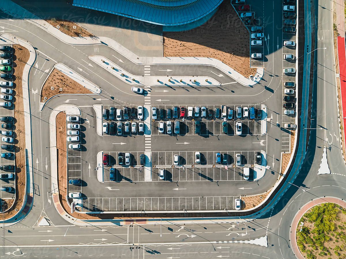 Aerial view of an airport car park with rows of parked cars
